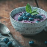 Freshly made blueberry compote in a rustic bowl with a spoon.